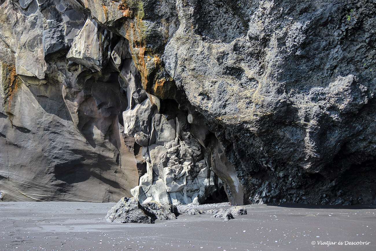 detalls de les columnes de bassalt i la sorra negra de la platja Reynisfjara